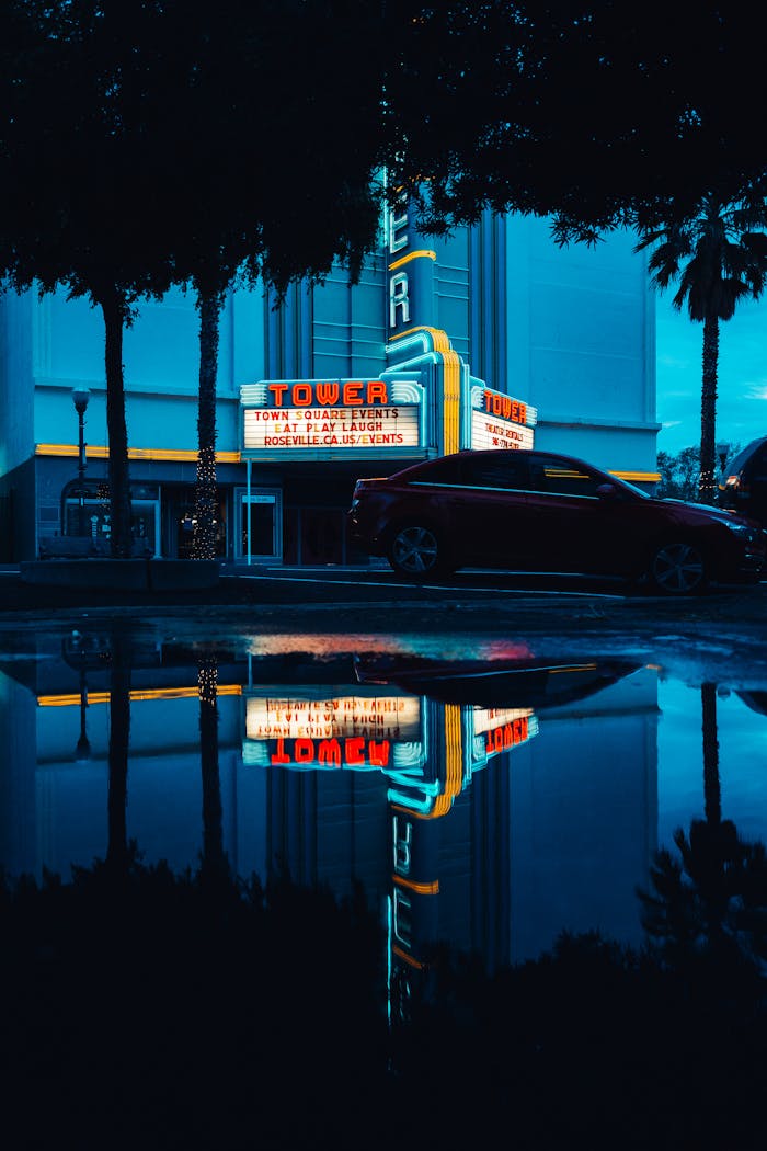 Night scene with vintage car reflections in a neon-lit urban parking lot. Captivating urban mood.